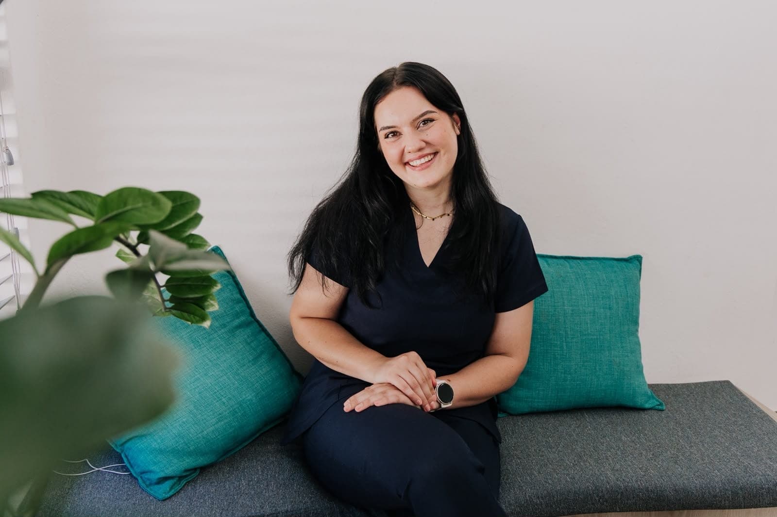 Monique van der Merwe, speech-language therapist, seated in her warm, light-filled practice room